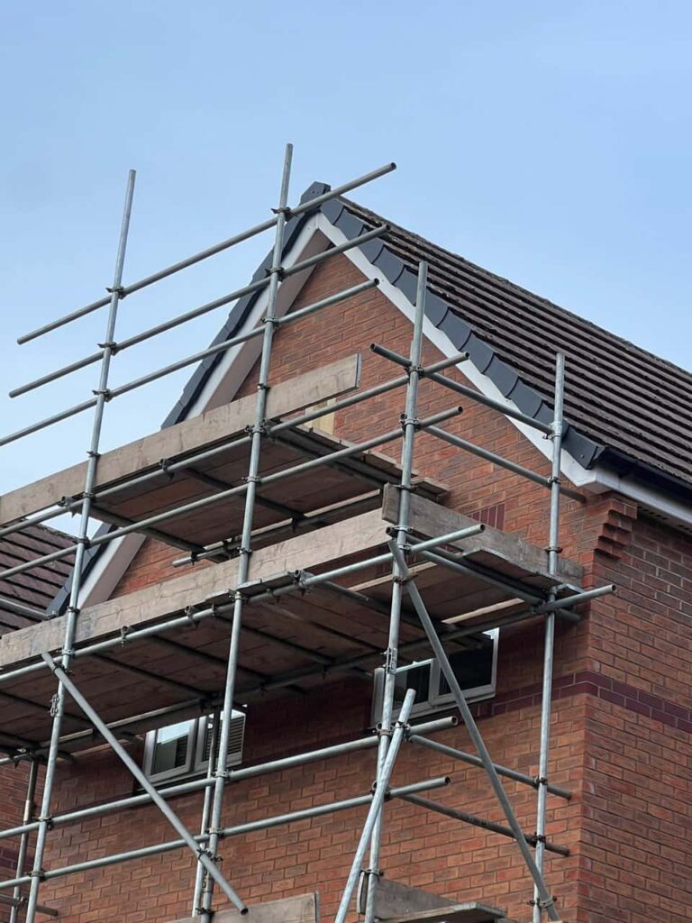 This is a photo of a roof which has just been repaired. There is a scaffold located at the gable end for access onto the roof. Works carried out by Saffron Walden Roofing Repairs